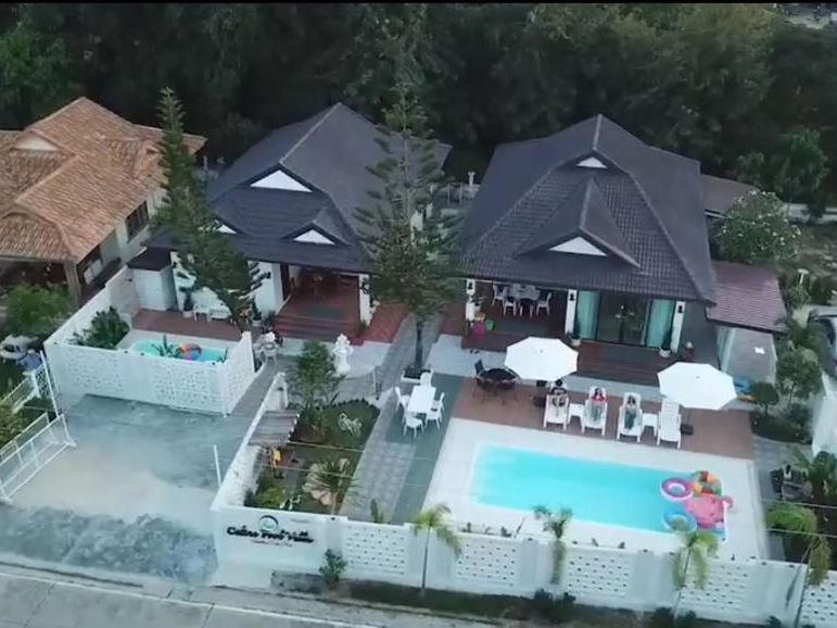 Aerial view of the whole property — two villas, the pool and parking