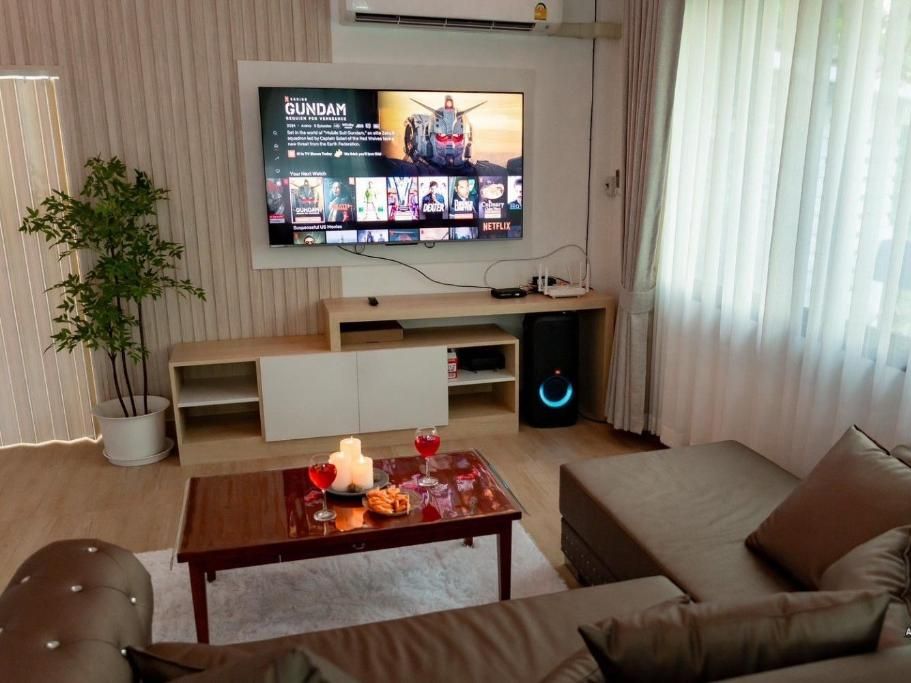 The second lounge with a wall-mounted TV and sofa