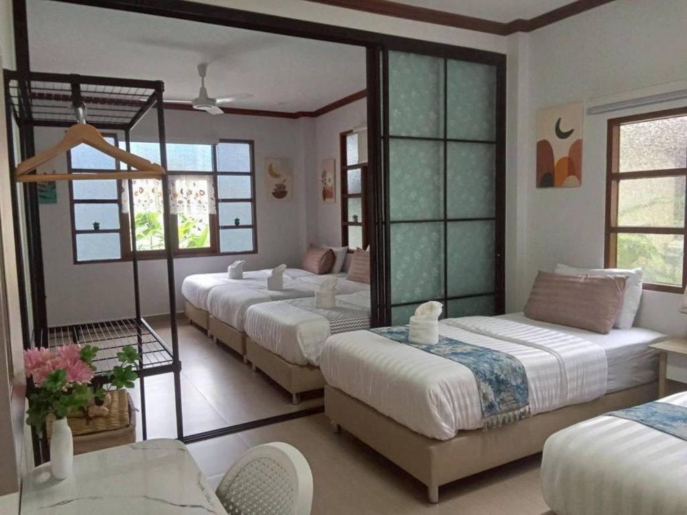 A large bedroom with several beds, sleeping a group